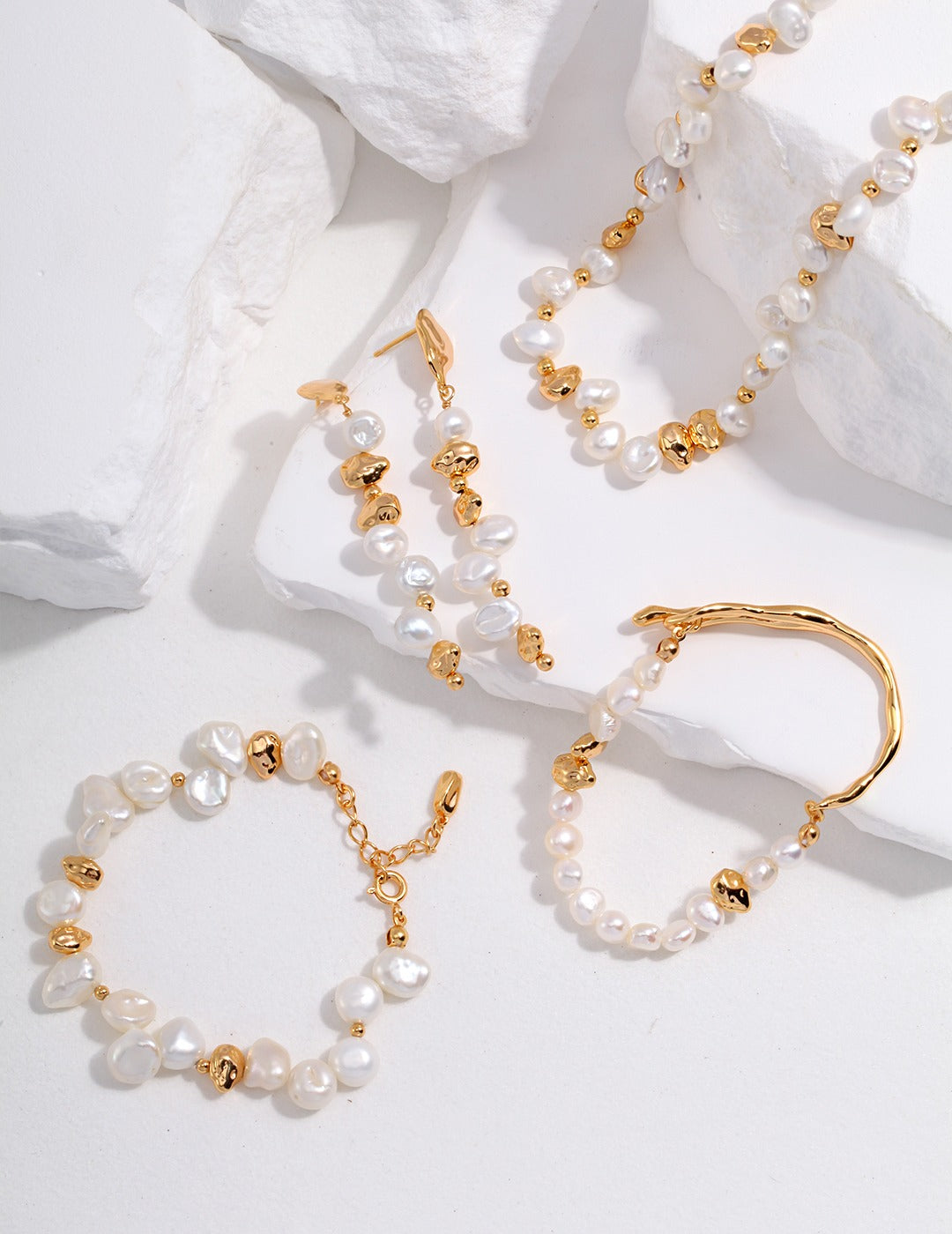 Freshwater pearl jewellery with warm gold-tone details on a white background