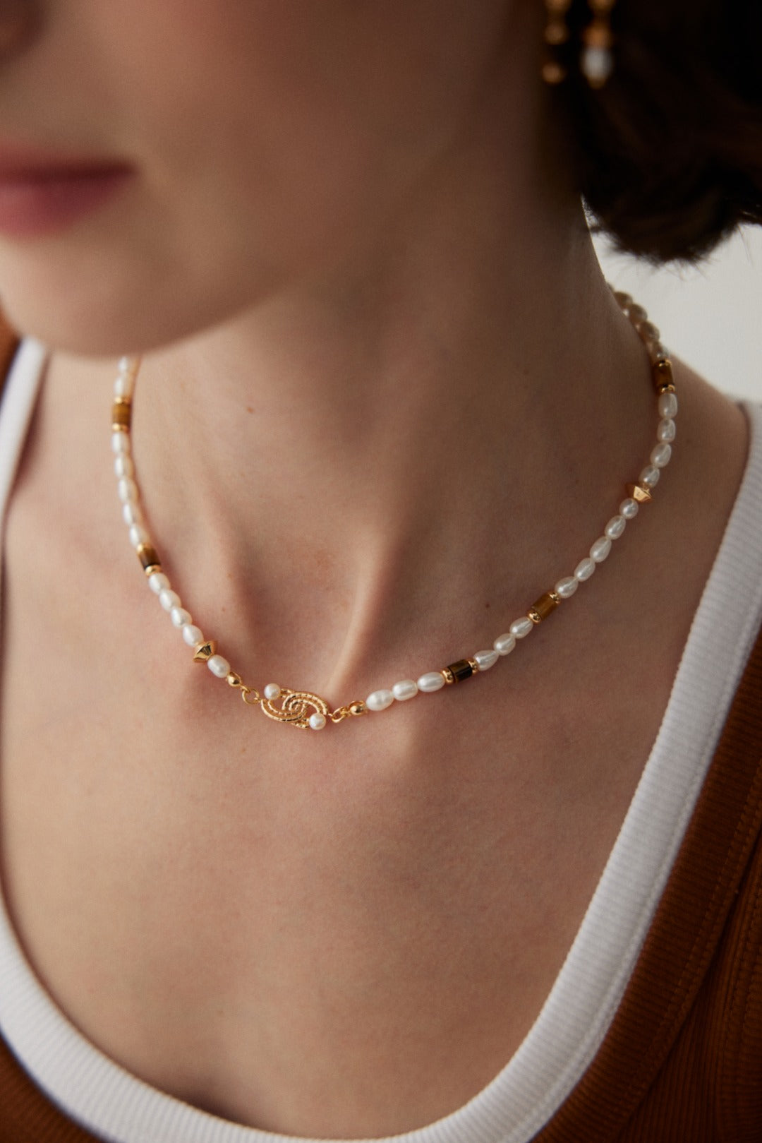 Freshwater pearl and tiger eye necklace styled with a warm neutral top