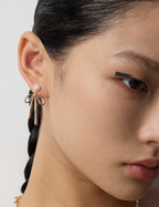 Side view of bow pearl drop earrings showing pearl position and movement