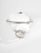 Close-up of sterling silver butterfly ring showing CZ accents and wing-like curves