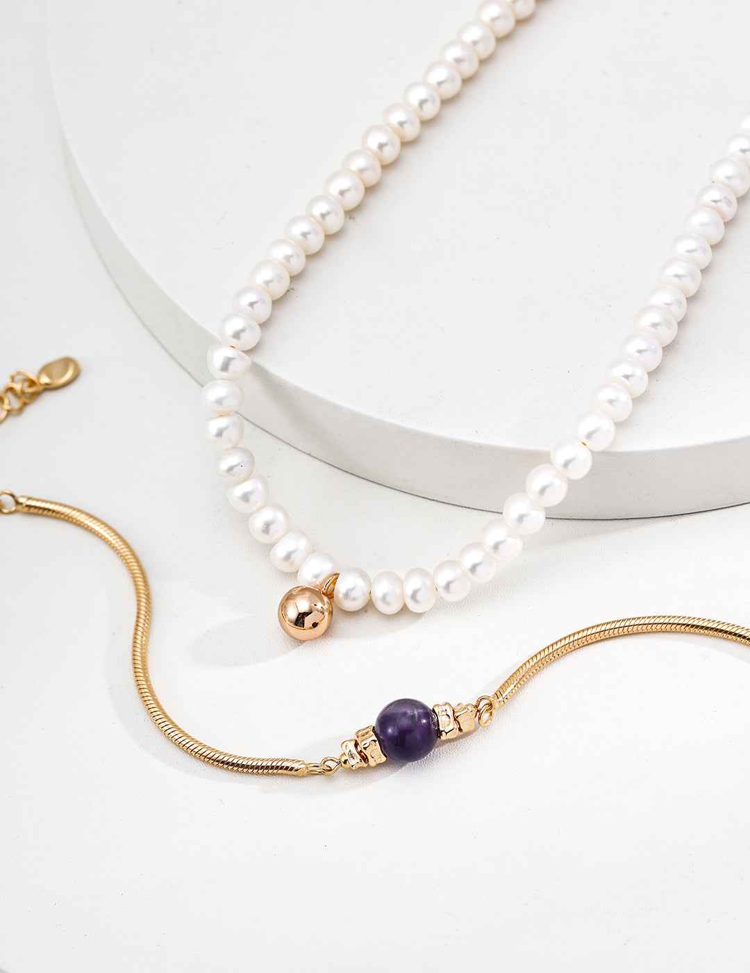Sterling silver amethyst bracelet worn on wrist, slim chain with center stone