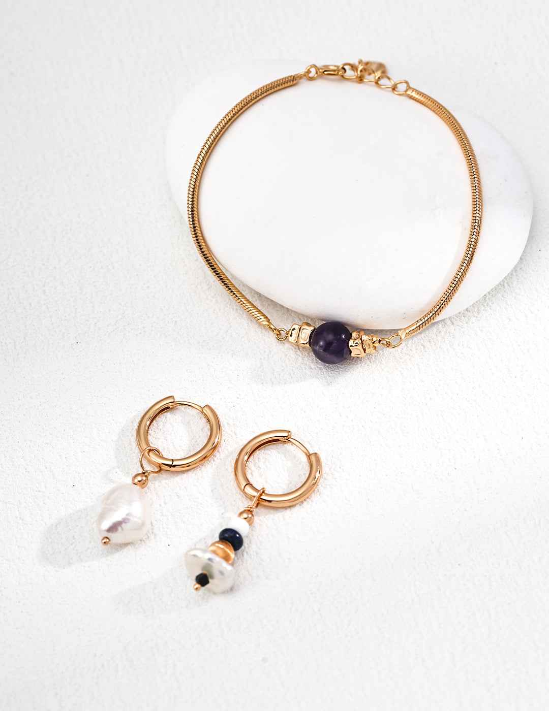 Close-up of 925 sterling silver amethyst bracelet showing stone and gold-tone frame detail