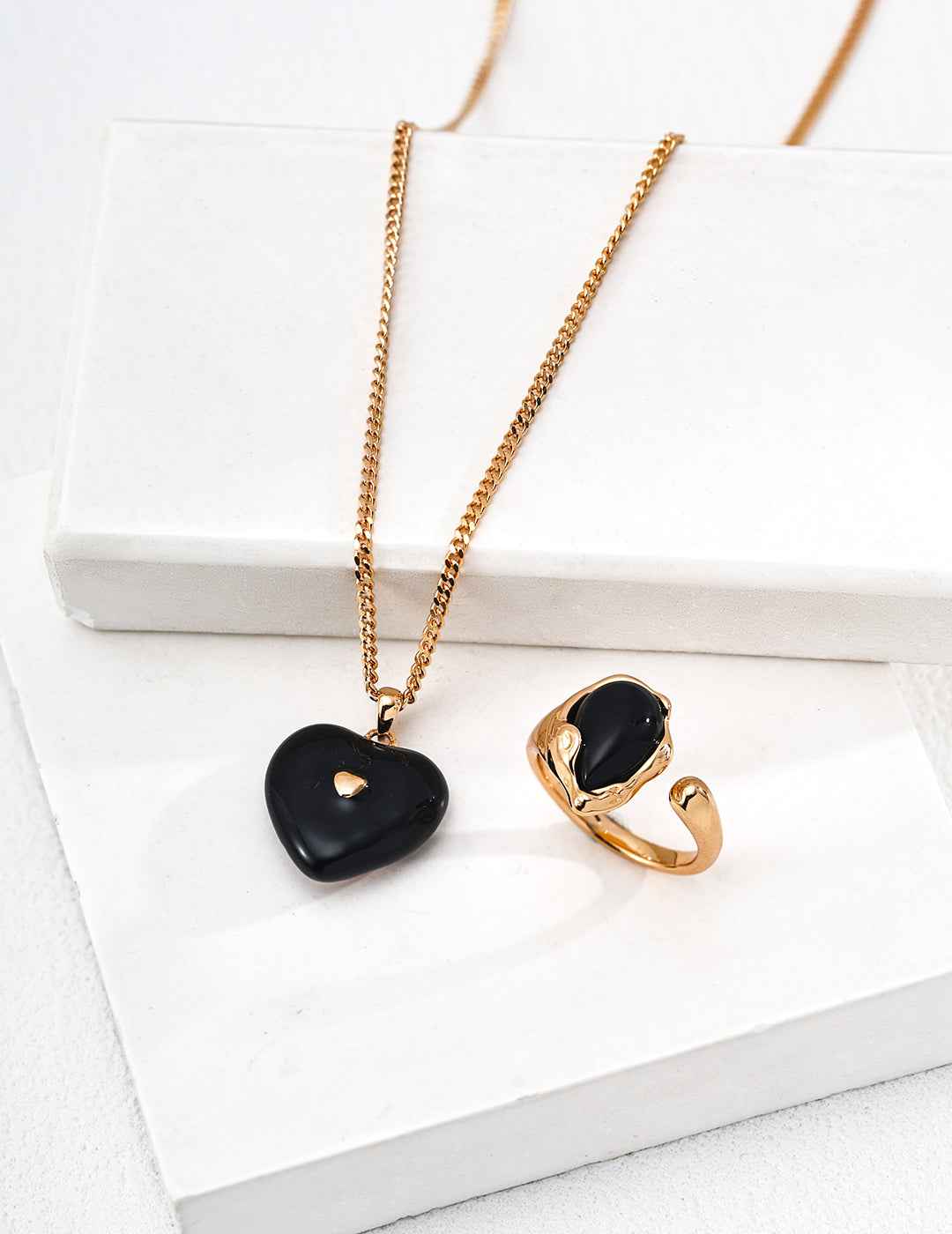 925 sterling silver necklace with compact heart-shaped black enamel pendant, vintage gold tone