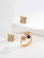 Close-up of sterling silver clover CZ stud earrings showing dimensional form and stone detail