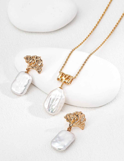 Close-up of baroque pearl pendant showing natural irregular surface and sterling silver chain setting