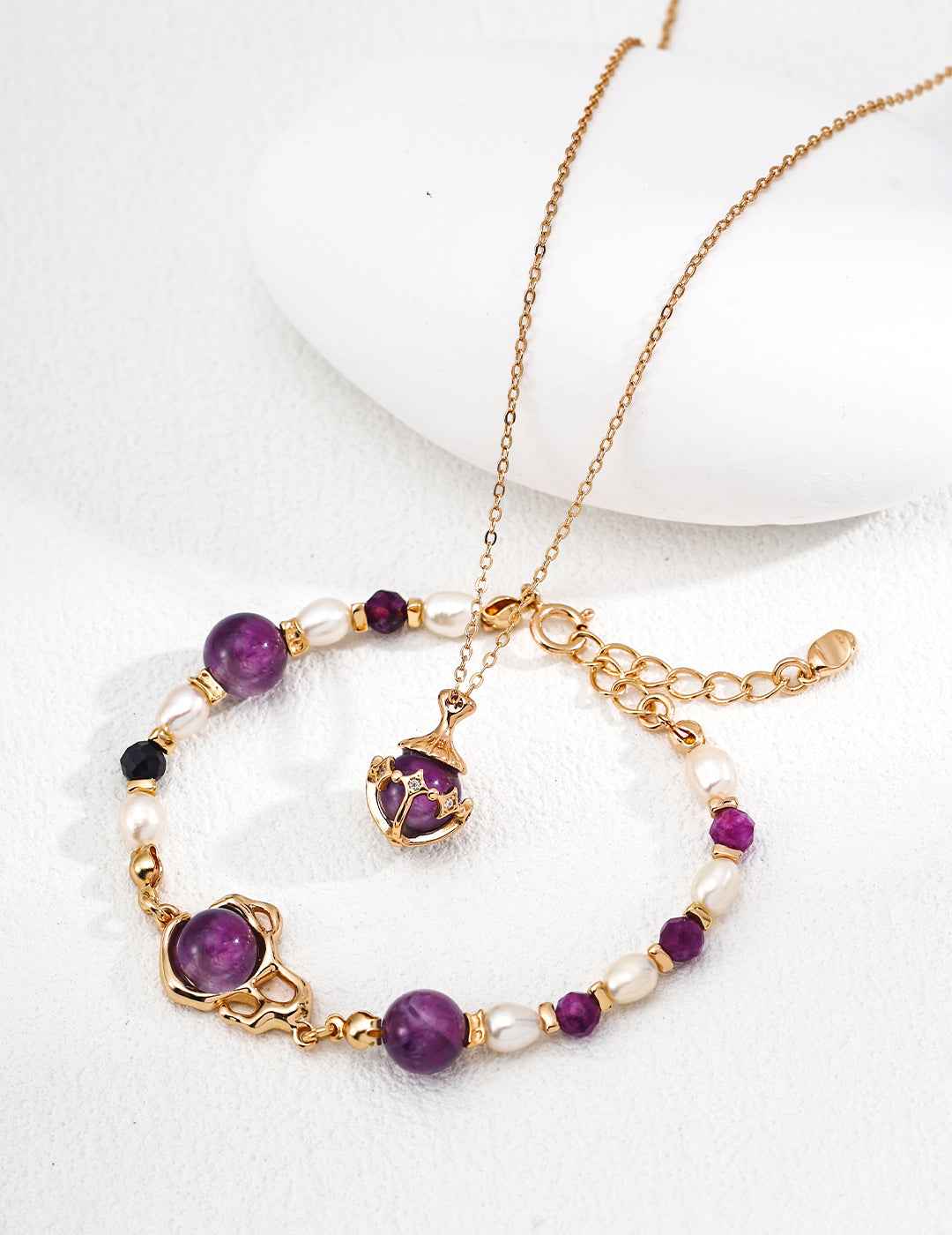 Close-up of sterling silver pendant showing amethyst stone and CZ accent detail