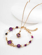 Close-up of sterling silver pendant showing amethyst stone and CZ accent detail