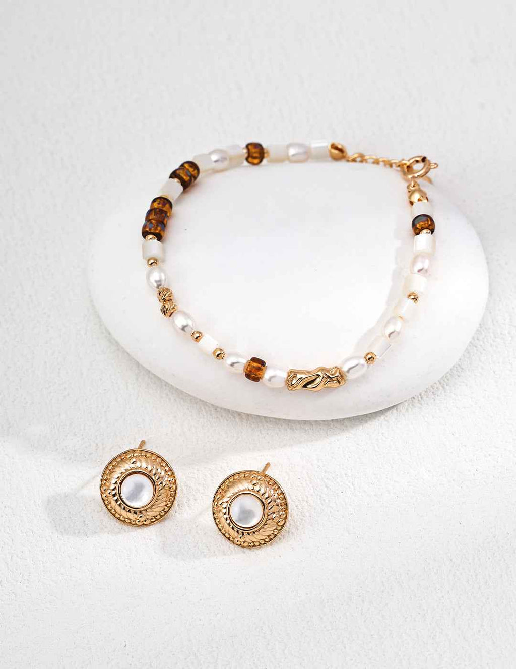 Close-up of colored glass and pearl beaded bracelet showing translucent glass and pearl surface detail