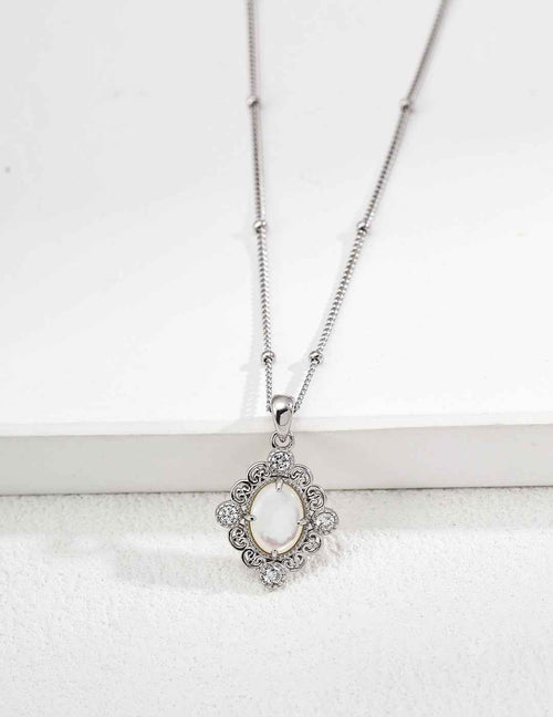 Close-up of sterling silver pendant showing amethyst stone in ornate frame with CZ accents