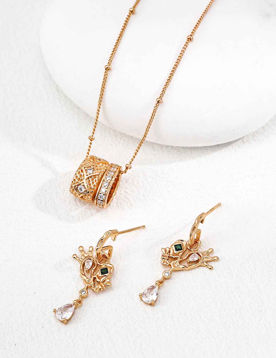 Close-up of sterling silver crown heart drop earrings showing CZ stone detail