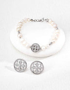 Detail view of 925 sterling silver freshwater pearl bracelet with floral cubic zirconia charm