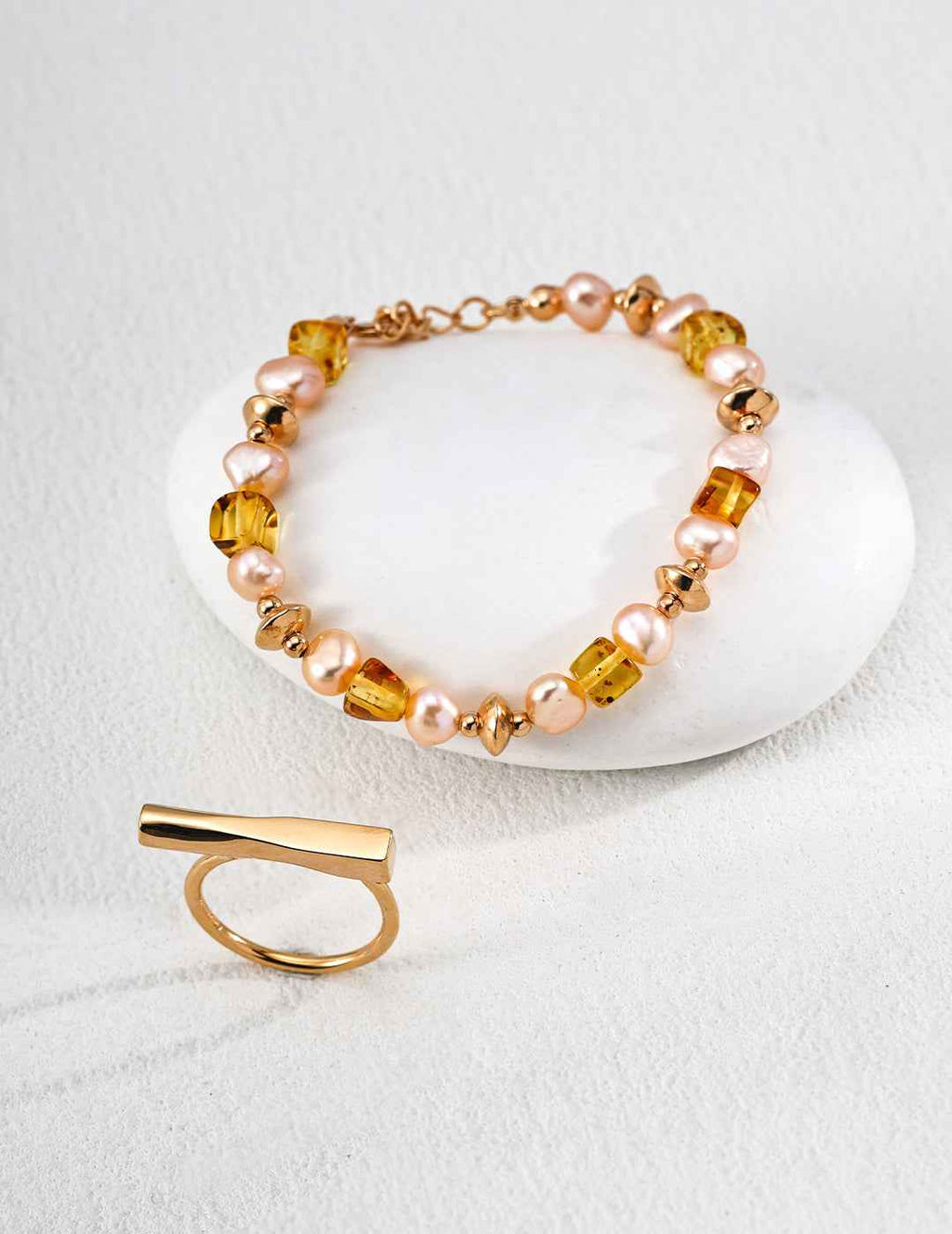 Side view of 925 sterling silver amber and freshwater pearl bracelet showing chain detail