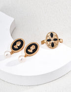 Natural pearl drop detail on black enamel earrings, pearl approx. 6 mm