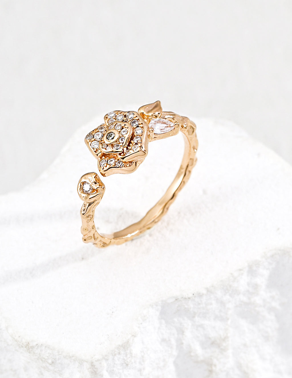 Close-up of sterling silver camellia ring showing flower motif and CZ stone detail