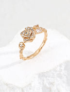 Close-up of sterling silver camellia ring showing flower motif and CZ stone detail
