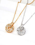 925 sterling silver coin pendant necklace with cubic zirconia, circular engraved design, gold tone