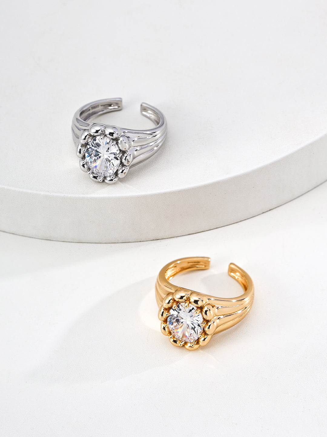 925 sterling silver adjustable ring with sculptural geometric form and cubic zirconia, gold tone