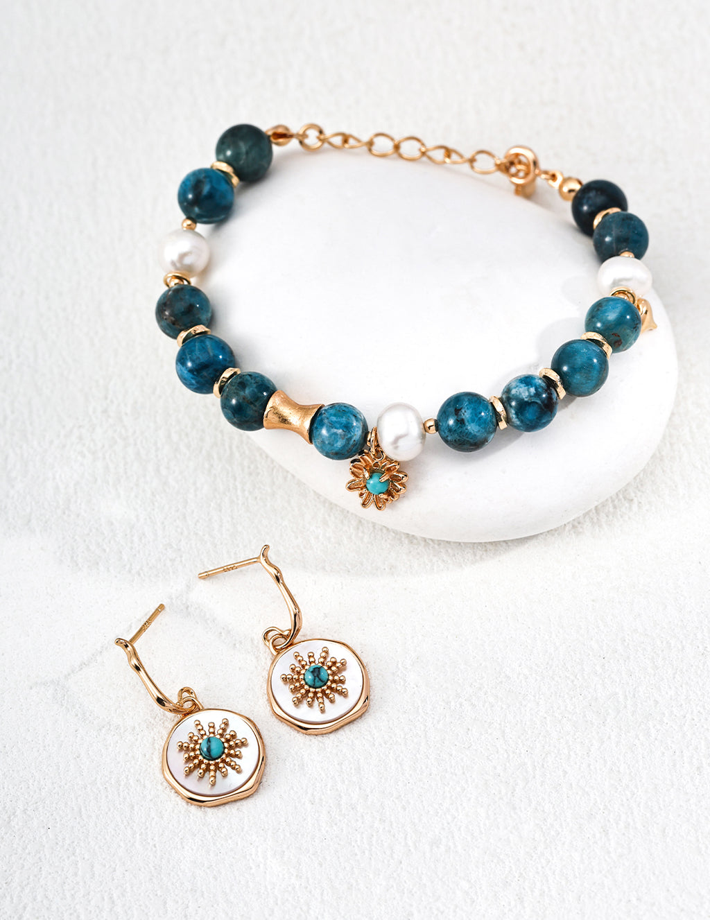 Close-up of 925 sterling silver drop earrings showing turquoise and mother of pearl stone detail