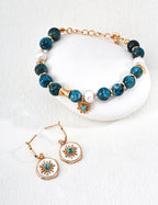 Close-up of 925 sterling silver drop earrings showing turquoise and mother of pearl stone detail