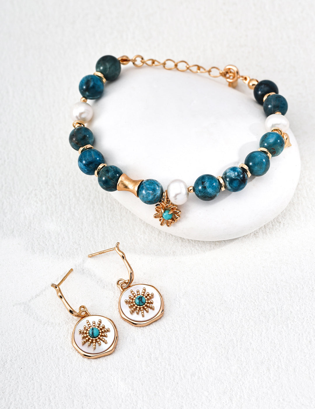 Close-up of 925 sterling silver drop earrings showing turquoise and mother of pearl stone detail