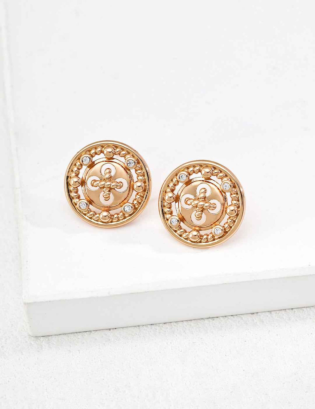 Close-up of sterling silver CZ round stud earring showing textured surface detail