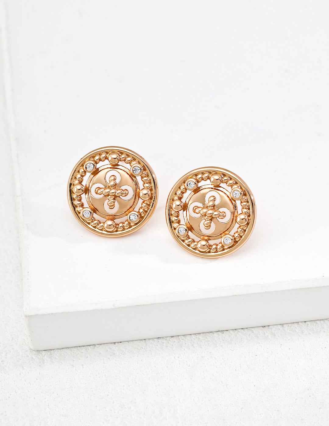 Close-up of sterling silver CZ round stud earring showing textured surface detail