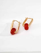 Close-up of 925 sterling silver agate drop earrings showing stone surface and gold-tone setting detail