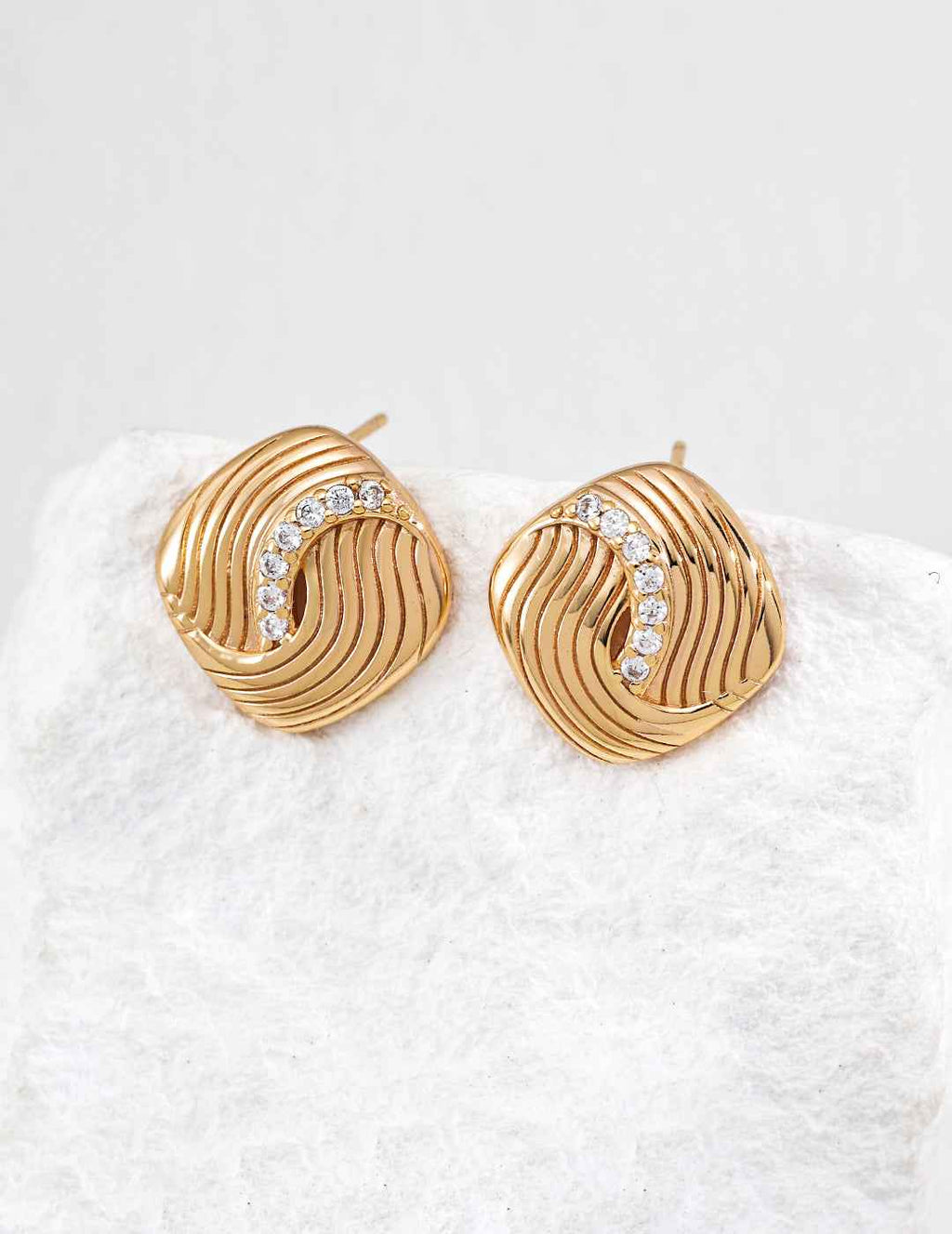 Close-up of sterling silver CZ twisted stud earring showing surface texture detail