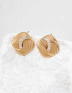 Close-up of sterling silver CZ twisted stud earring showing surface texture detail