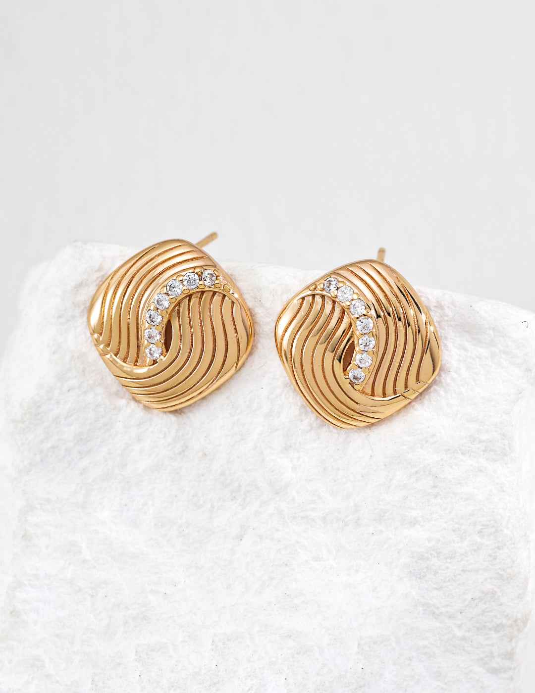 Close-up of sterling silver CZ twisted stud earring showing surface texture detail