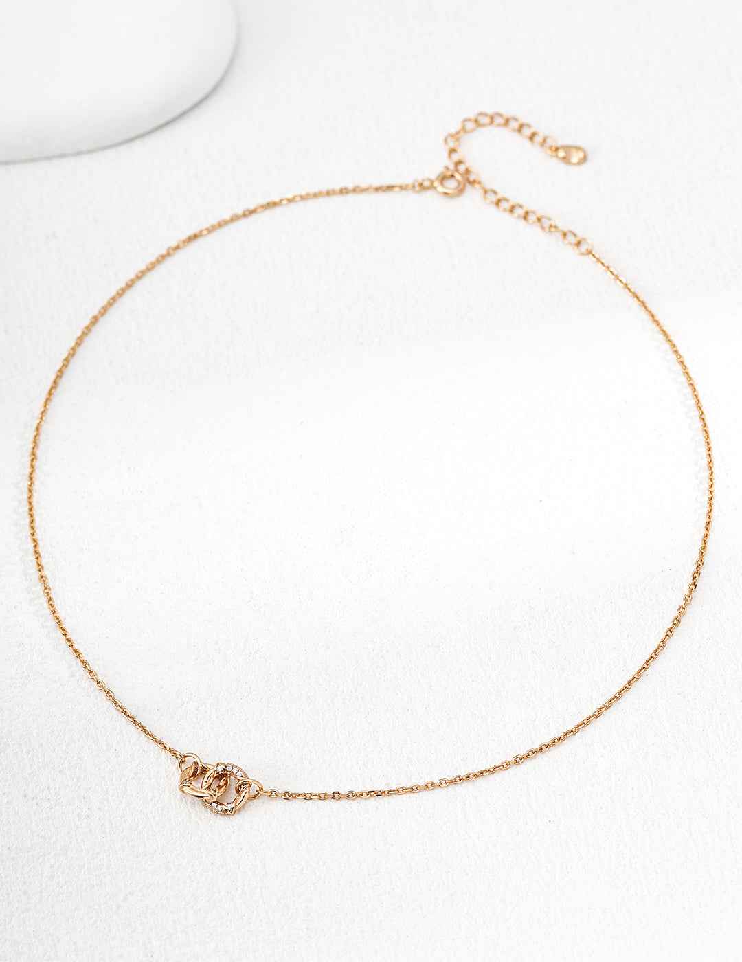 Full length view of 925 sterling silver CZ knot pendant necklace, 38 cm chain