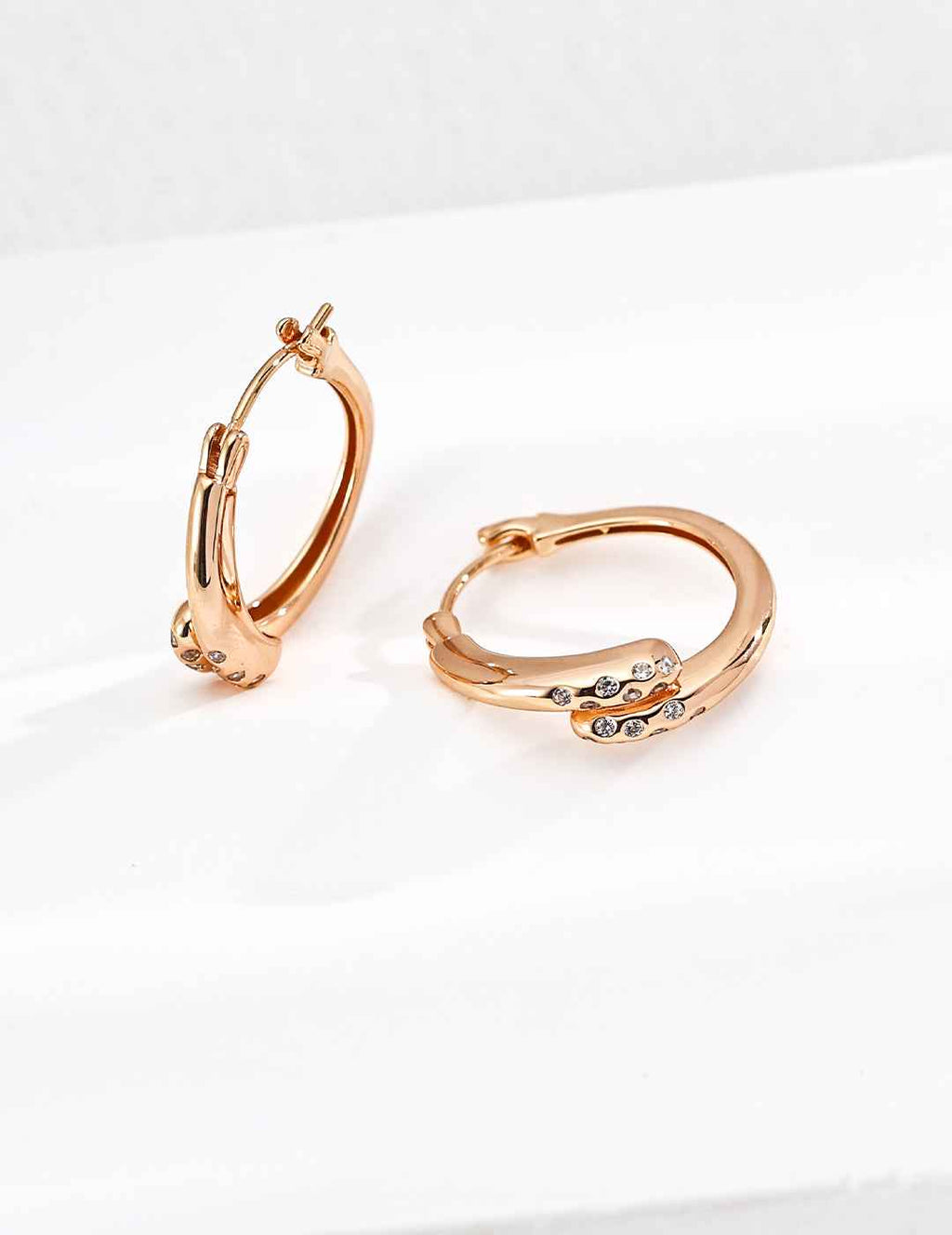Pair of 925 sterling silver cubic zirconia twisted hoop earrings, front view