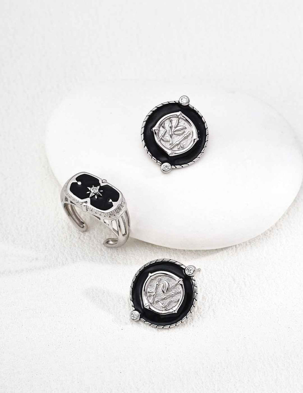 Side view of coin motif earrings showing layered enamel and metal relief structure