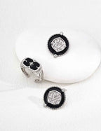 Side view of coin motif earrings showing layered enamel and metal relief structure