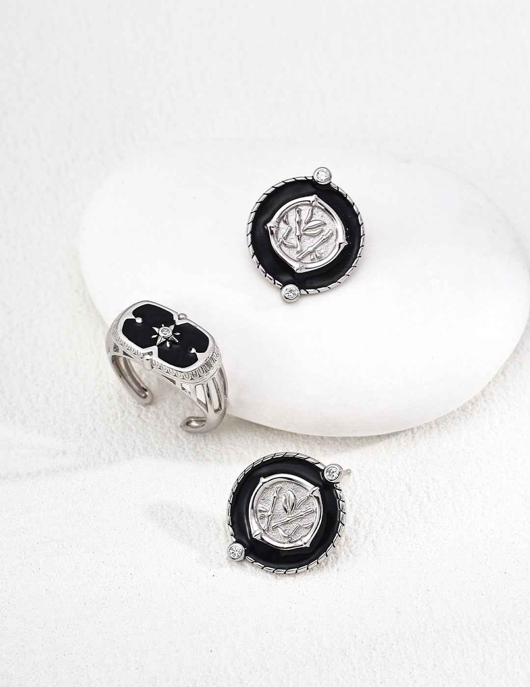 Side view of coin motif earrings showing layered enamel and metal relief structure