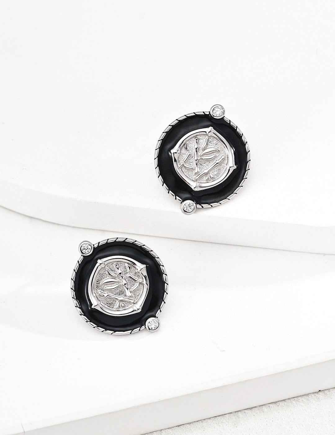 Front view of 925 sterling silver coin earrings showing balanced circular design