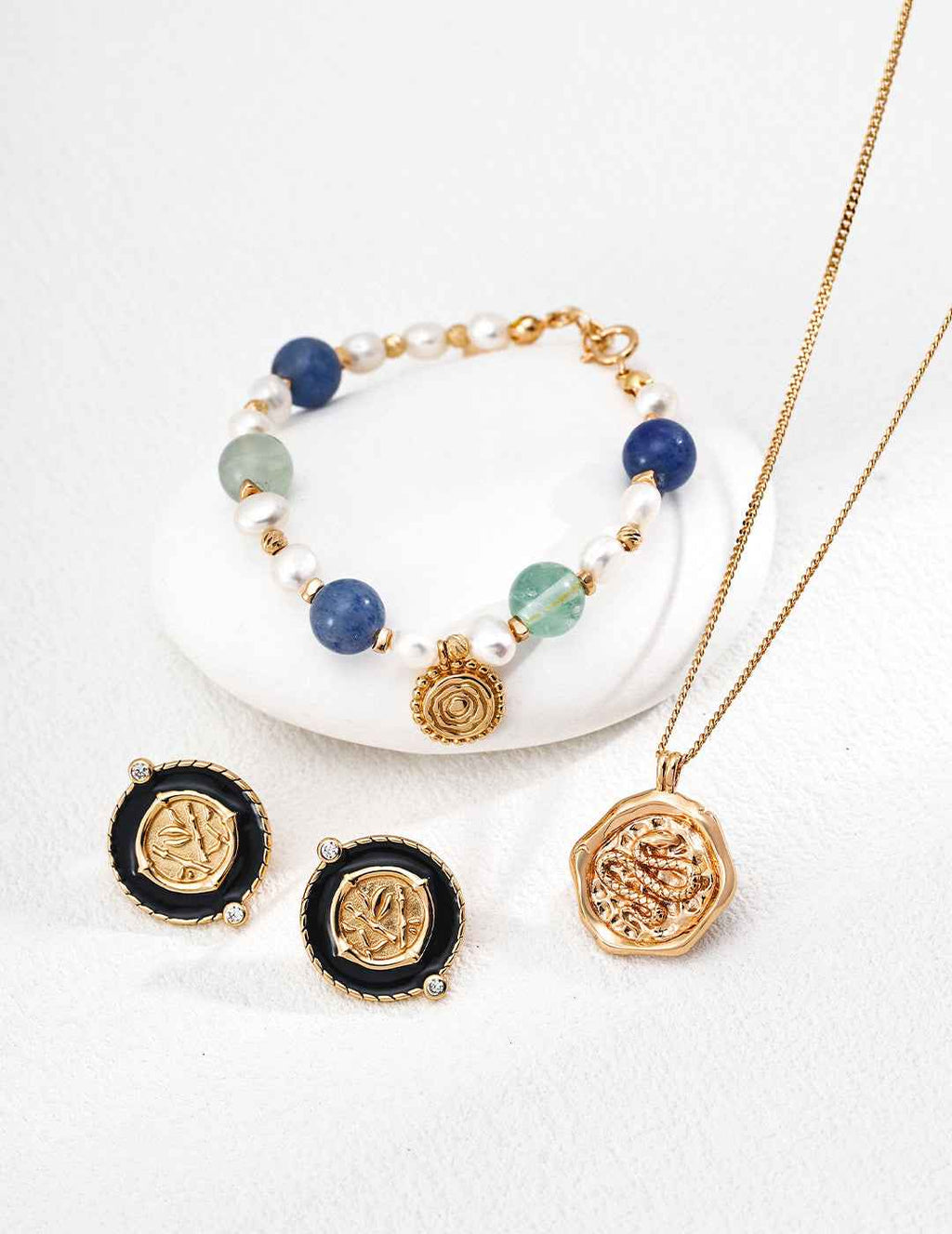 Close-up of coin earring showing textured enamel edge and pavé cubic zirconia detail
