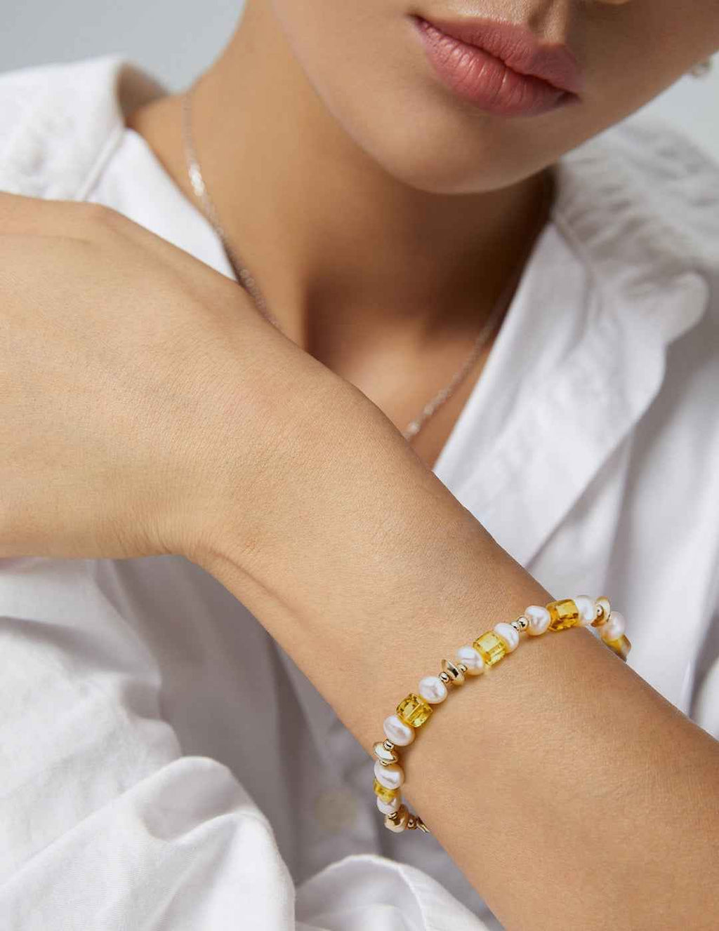 Close-up of amber and freshwater pearl bracelet showing bead sizes and surface texture