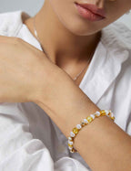 Close-up of amber and freshwater pearl bracelet showing bead sizes and surface texture