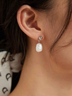 925 sterling silver baroque pearl earrings worn on ear showing natural pearl shape